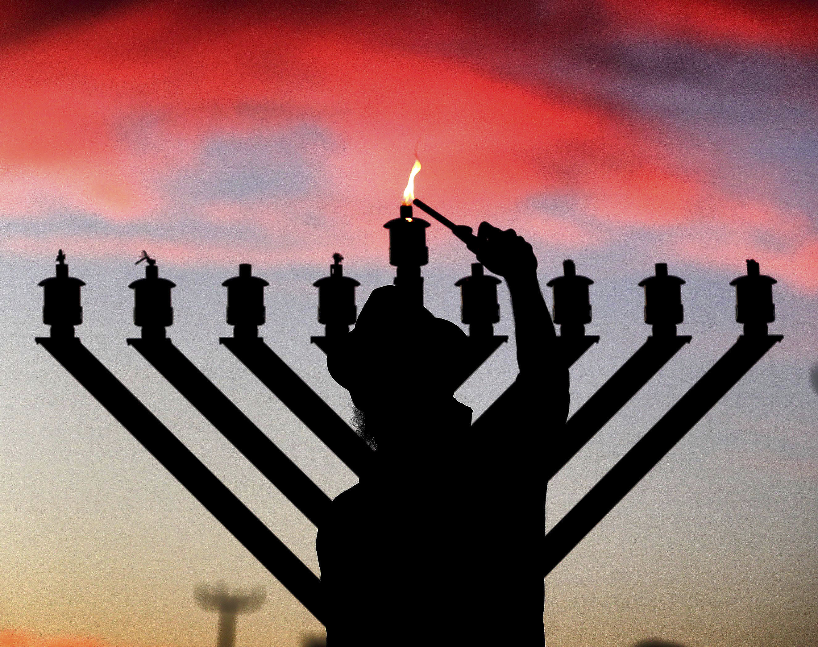 (Joe Burbank | Orlando Sentinel via AP) A menorah is lit in Orlando, Florida, in 2020. A Utahn has been charged with threatening to blow up a synagogue.