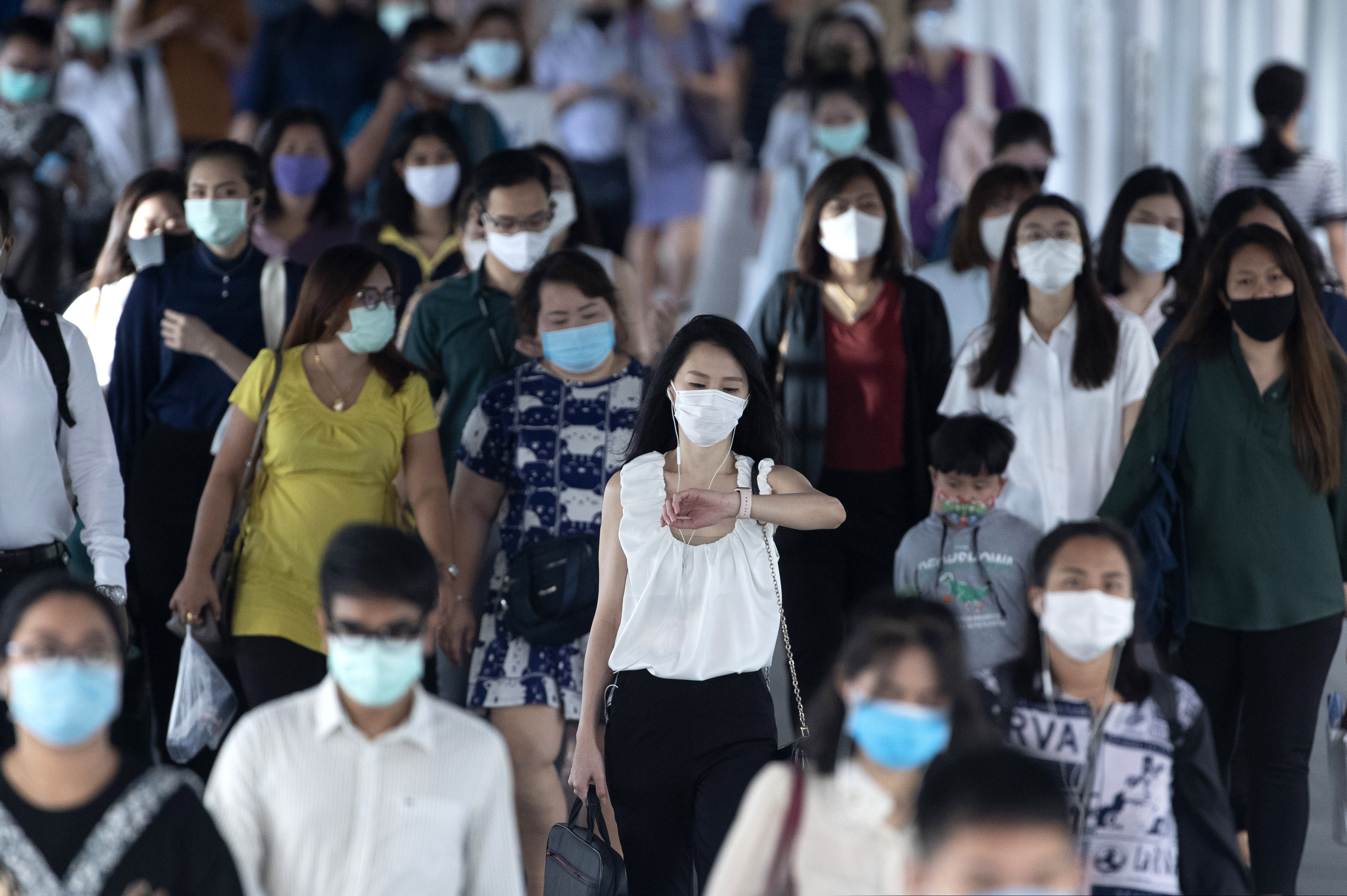 (Sakchai Lalit | AP file photo) Office workers wearing face masks to help curb the spread of the coronavirus head to worlplaces in Bangkok, Thailand, Thursday, May 21, 2020. Thai health officials say scientists in Thailand have had promising results in testing a COVID-19 vaccine candidate on mice, and will begin testing it on monkeys next week.