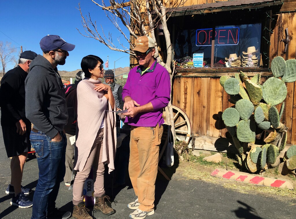 (AP Photo/Krysta Fauria) John Lauretig, executive director of Friends of Joshua Tree, talks to visitors at Coyote Corner, outside the entrance to Joshua Tree National Park in the southern California desert Thursday, Jan. 3, 2019. President Donald Trump made a surprise appearance in the White House briefing room Thursday on the 13th day of the partial government shutdown, as he continued to dig in his heels over his promised border wall.