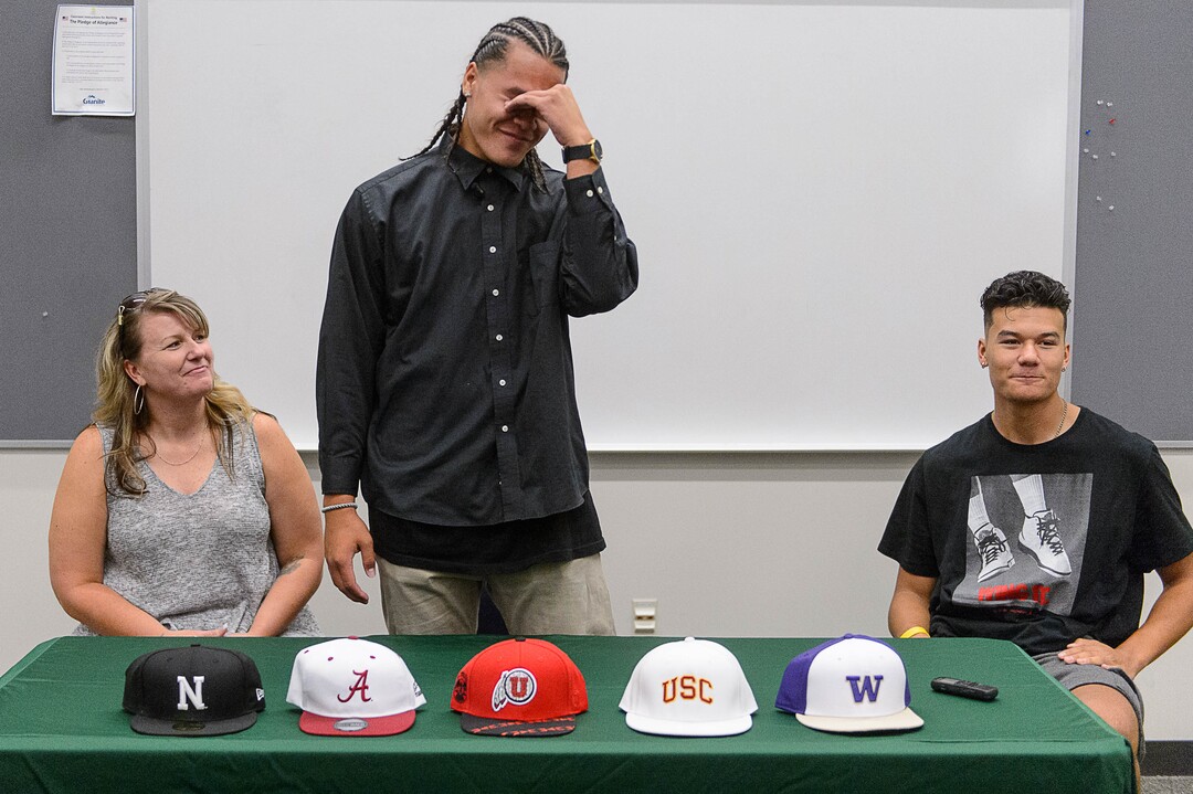 (Trent Nelson  |  The Salt Lake Tribune)  Olympus tight end Cameron Latu announces he's headed to Alabama during a news conference at Olympus High School in Salt Lake City Friday August 4, 2017. His mother Jill Argust at left, and brother Nate Latu at right.