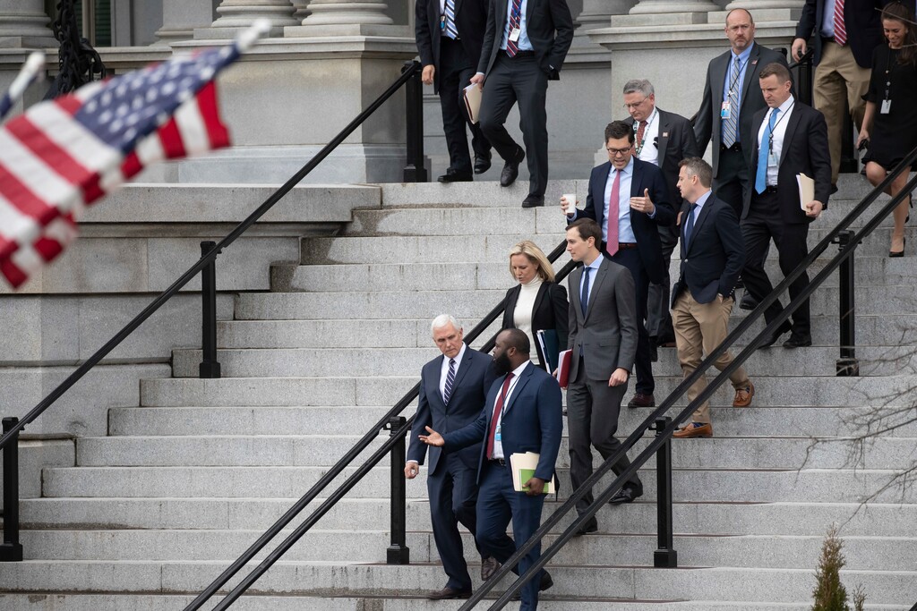 (AP Photo/Alex Brandon) Vice President Mike Pence, left, White House legislative affairs aide Ja'Ron Smith, Homeland Security Secretary Kirstjen Nielsen, second row left, White House Senior Adviser Jared Kushner, and others, walk down the steps of the Eisenhower Executive Office building, on the White House complex, after a meeting with staff members of House and Senate leadership, Saturday, Jan. 5, 2019, in Washington.