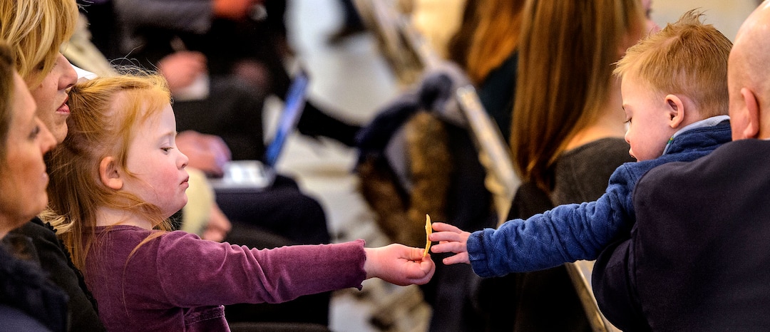 (Steve Griffin  |  The Salt Lake Tribune) Four-year-old Ella Warner, left, shares a chip with her three-year-old friend Finn Merkley as Rep. Karianne Lisonbee, R-Clearfield talks about legislation that would enact important protections for children who have Down syndrome during a news conference at the Utah State Capitol in Salt Lake City Monday January 22, 2018. Both children, who have Down Syndrome, attended the news conference with their parents Natalie Warner and Justin Merkley. Amber Merkley, Finn's mother, spoke during the event. 