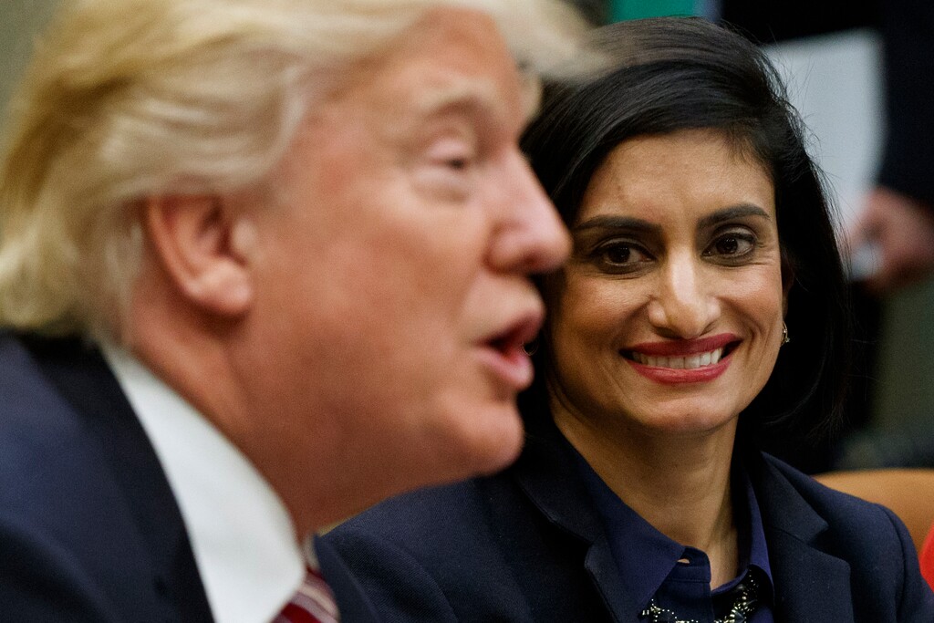 FILE - In this March 2017 file photo, Seema Verma, administrator of the Centers for Medicare and Medicaid Services, listens as President Donald Trump speaks during a meeting in the Roosevelt Room of the White House in Washington. The Trump administration says it's offering a path for states that want to seek work requirements for Medicaid recipients, and that's a major policy shift toward low-income people.  (AP Photo/Evan Vucci, File)