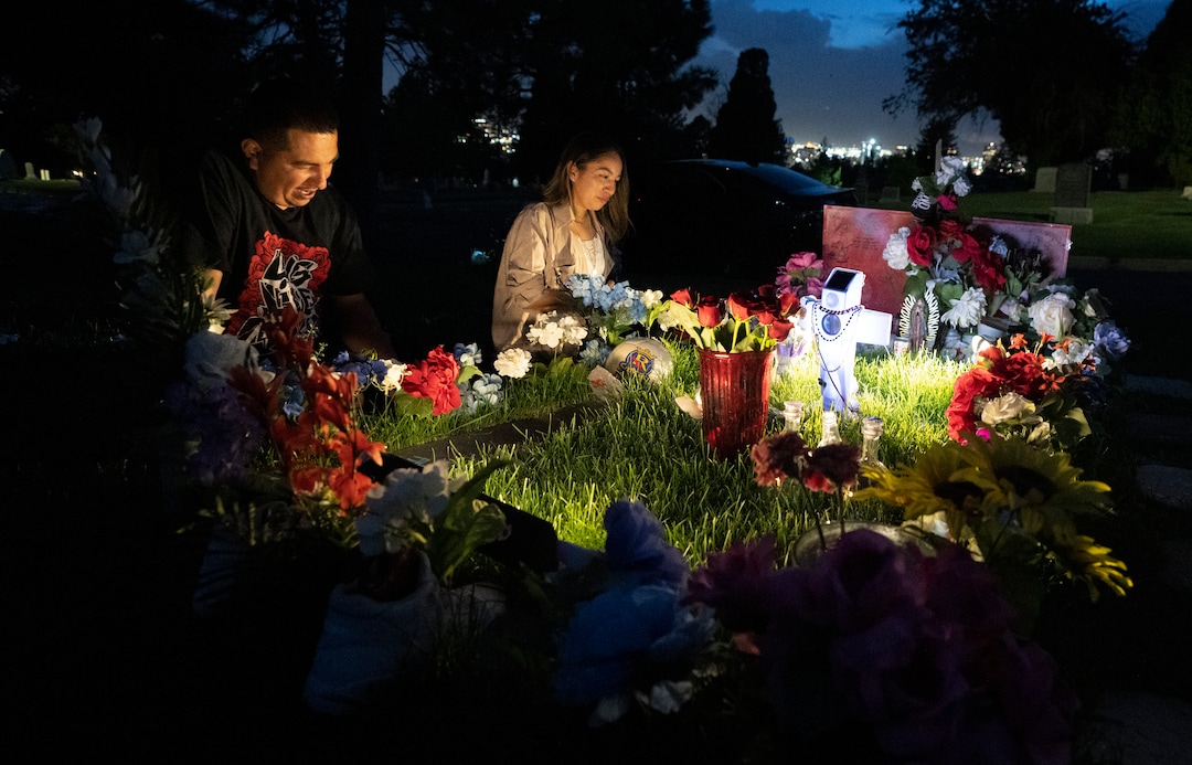 (Rick Egan | The Salt Lake Tribune) Freddie and Karina, the brother and sister of Bernardo Palacios-Carbajal, place flowers on Bernardo's gravesite at the Salt Lake City Cemetery, on Wednesday, May 19, 2021.