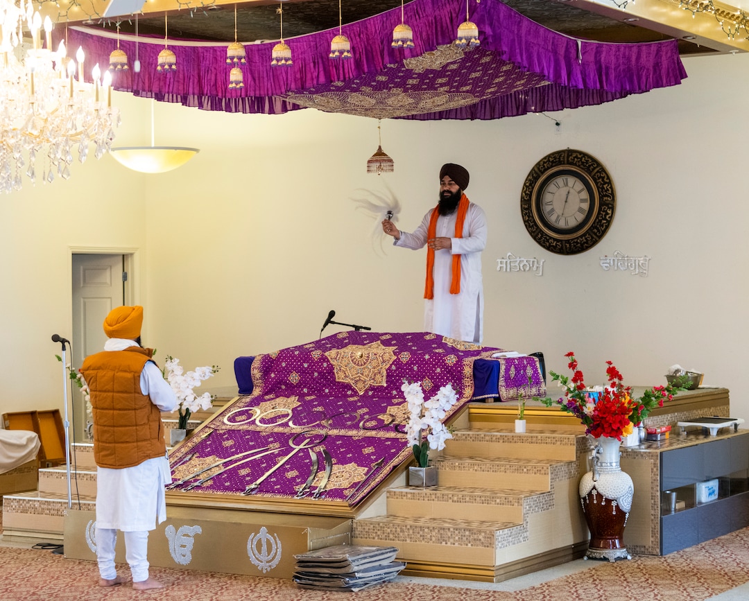 (Rick Egan | The Salt Lake Tribune) Bachider Singh and  Kuljeat Singh bless wool blankets that members of the Sikh community are donating to help the unsheltered stay warm during a blessing ceremony at the Sikh temple in Taylorsville on Thursday, Dec. 23, 2021.