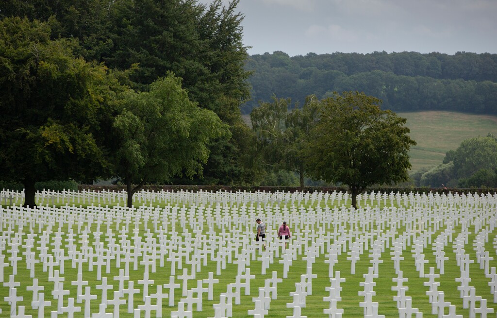 (Virginia Mayo | AP photo) In this photo taken on Aug. 8, 2019, visitors walk among the headstones at the Henri Chapelle World War II cemetery in Henri Chapelle, Belgium. The cemetery contains 7,992 American war dead and covers 57 acres. It was 75 years before that Hitler launched his last desperate attack to turn the tide for Germany in World War II. At first, German forces drove so deep through the front line in Belgium and Luxembourg that the month-long fighting came to be known as The Battle of the Bulge.