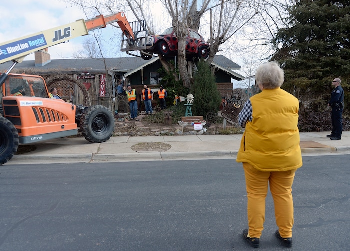 (Al Hartmann | The Salt Lake Tribune)
Clearfield public works personnel use a crane to remove Janis Zettel's gutted VW Beetle from a tree in her front yard Tuesday Feb. 13. She put it up a few months ago as an art installation. Now it has to come down.