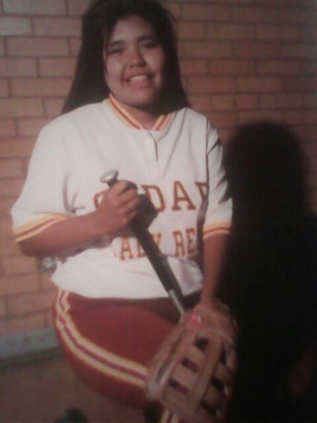 (Photo courtesy of Merrilee Ham) Merrilee Ham poses for a portrait as a sophomore on the Lady Reds softball team in 1993 at Cedar High School in Cedar City. CHS officials are considering dropping the school's controversial team name: The Redmen. Ham is a member of the Paiute Indian Tribe of Utah and said that she, her siblings, her cousins and her children all have been proud CHS athletes under the Redmen name. Others have decried the mascot as a racial slur.