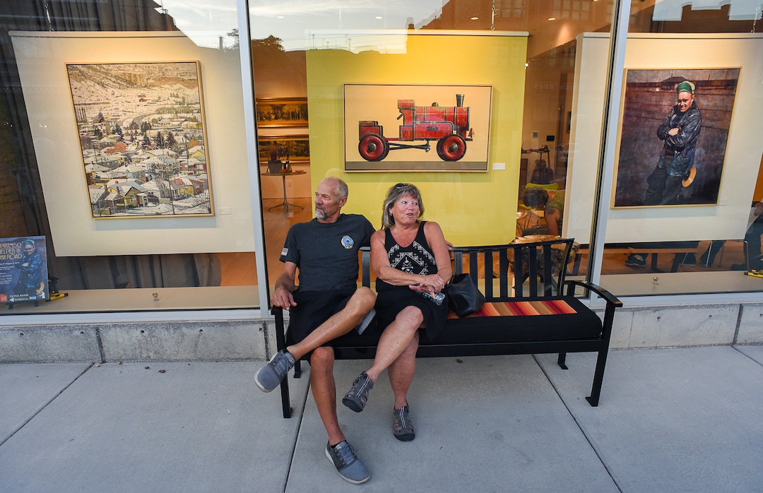 (Francisco Kjolseth  |  The Salt Lake Tribune)  Taking in the scene on a warm summer evening, 44-year locals Mike and Cindy Schmitz enjoy Helper's First Fridays gallery stroll on Friday, Aug. 2, 2019. The monthly event draws all ages with activities, food, and artists opening up their studios and galleries to visitors.