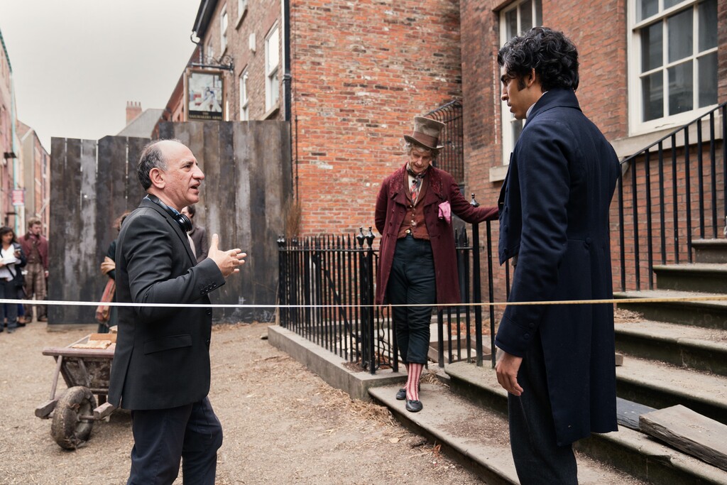 (Photo courtesy of Searchlight Pictures) Director Armando Iannucci, left, on the set of "The Personal History of David Copperfield," talking to actors Peter Capaldi, center, as Micawber, and Dev Patel as David Copperfield. The movie opens in U.S. theaters on Aug. 28, 2020.