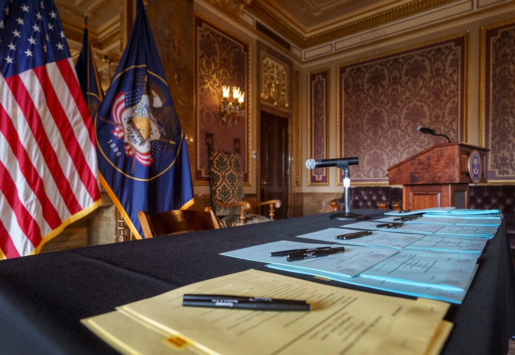 (Leah Hogsten | The Salt Lake Tribune) A table laden with Utah House and Senate bills awaits Gov. Spencer Cox's signature in the Capitol Gold Room, Mar. 22, 2023. Hundreds of new laws passed by the Legislature this year will become operational on Wednesday, May 3.