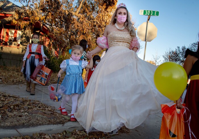 (Francisco Kjolseth  |  The Salt Lake Tribune) Michelle Binion accompanies her daughter Lizzie, 5, as they walk with friends while trick or treating on Saturday, Oct. 31, 2020, as they visit houses who signed up for the SugarHood Halloween, with every treat giving participant agreeing to abide by CDC Covid safety standards.