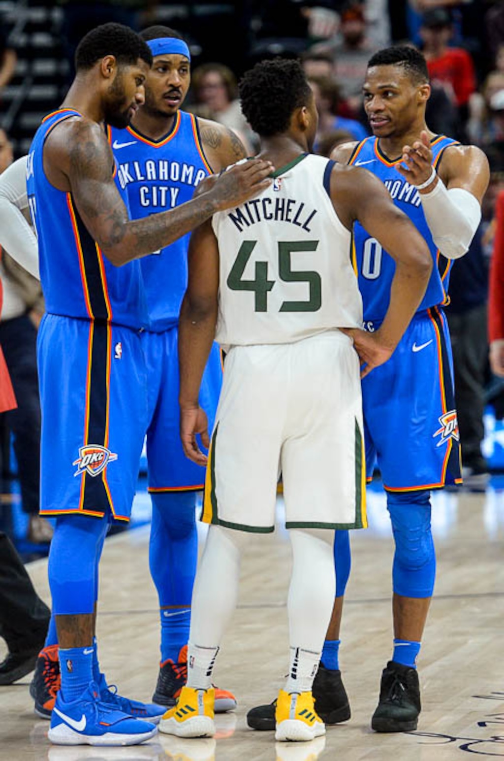 (Trent Nelson | The Salt Lake Tribune)  Oklahoma City Thunder forward Paul George (13), Oklahoma City Thunder forward Carmelo Anthony (7), and Oklahoma City Thunder guard Russell Westbrook (0) embrace and talk to Utah Jazz guard Donovan Mitchell (45) after the Utah Jazz lost to the Oklahoma City Thunder, NBA basketball in Salt Lake City, Saturday December 23, 2017.