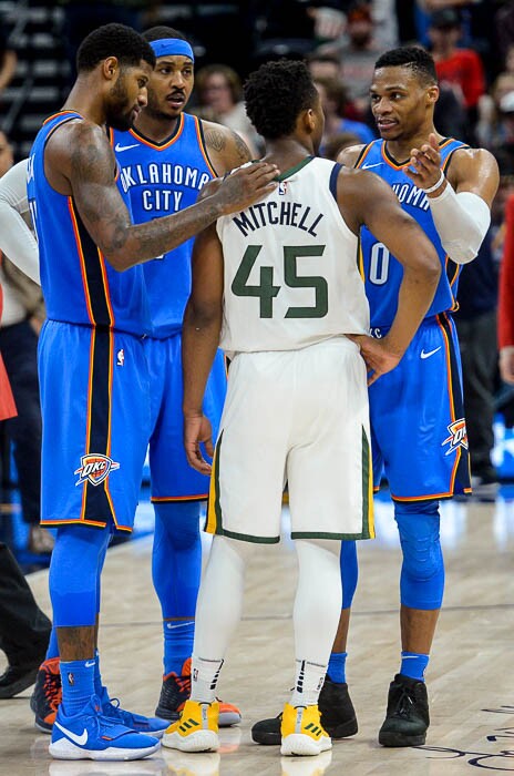 (Trent Nelson | The Salt Lake Tribune) Oklahoma City Thunder forward Paul George (13), Oklahoma City Thunder forward Carmelo Anthony (7), and Oklahoma City Thunder guard Russell Westbrook (0) embrace and talk to Utah Jazz guard Donovan Mitchell (45) after the Utah Jazz lost to the Oklahoma City Thunder, NBA basketball in Salt Lake City, Saturday December 23, 2017.