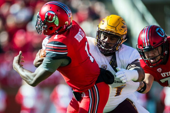 (Chris Detrick  |  The Salt Lake Tribune)  Utah Utes quarterback Tyler Huntley (1) is tackled by Arizona State Sun Devils defensive lineman JoJo Wicker (1) during the game at Rice-Eccles Stadium Saturday, October 21, 2017. 