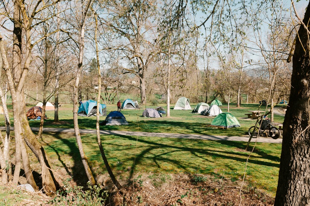 (Mason Trinca | The New York Times) An encampment at Tussing Park in Grants Pass, Ore., which has ticketed, fined and jailed the homeless for sleeping and camping in public spaces, March 18, 2024. In a 6-3 vote, split along ideological lines, the Supreme Court has upheld local laws aimed at banning homeless residents from sleeping outdoors, saying they did not violate the ConstitutionÕs prohibition on cruel and unusual punishment.