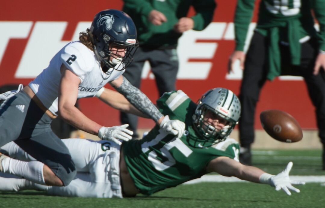 (Rick Egan  |  The Salt Lake Tribune)    Olympus receiver Noah Bennee stretches to try to catch a pass, as Corner Canyon defensive back, John Scheffner defends for the Chargers, in 5A football semifinal action between Olympus and Corner Canyon at Rice-Eccles Stadium, Thursday, Nov. 8, 2018.