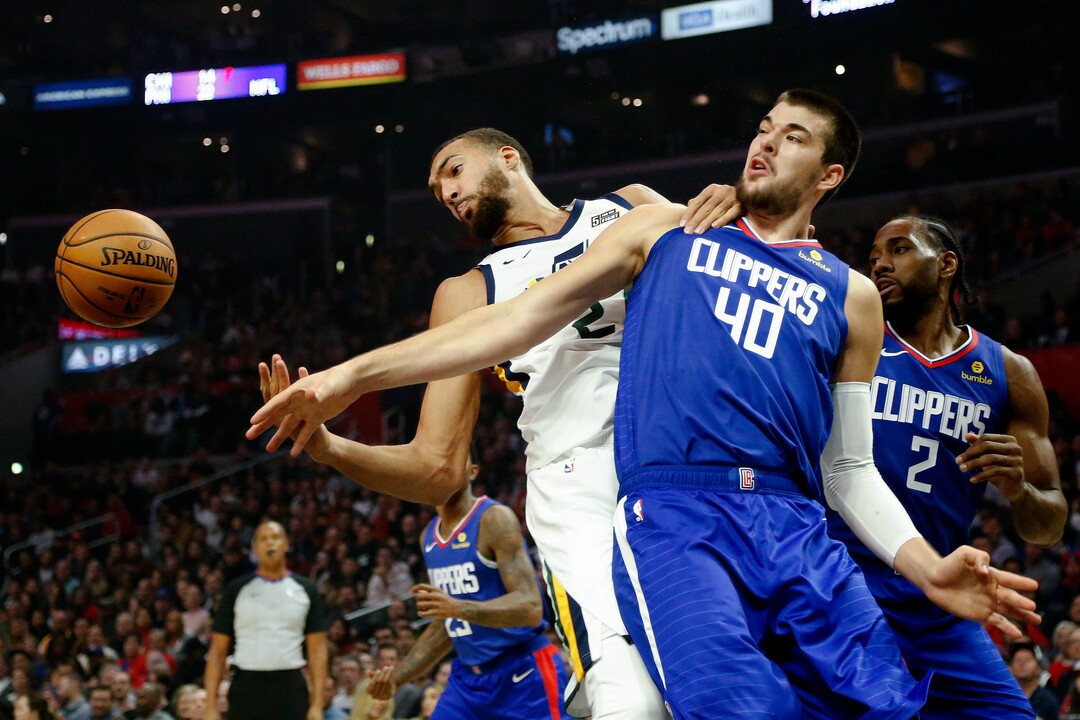Utah Jazz's Rudy Gobert (27) fights for a rebound against Los Angeles Clippers' Ivica Zubac (40) and Kawhi Leonard (2) during the first half of an NBA basketball game Sunday, Nov. 3, 2019, in Los Angeles. (AP Photo/Ringo H.W. Chiu)