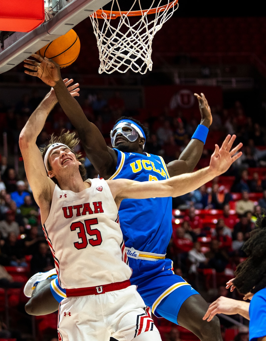 (Rick Egan | The Salt Lake Tribune) UCLA forward Adem Bona (3) is called for a foul, as Utah Utes center Branden Carlson (35) goes to the hoop, in PAC-12 basketball action between Utah Utes and UCLA Bruins, at the Jon M.Huntsman Center, Thursday, February. 23, 2022.