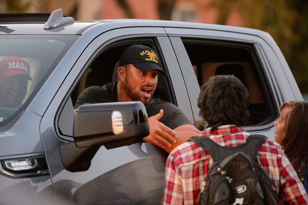 (Trent Nelson  |  The Salt Lake Tribune) A man in a truck with a Trump flag talks to protesters as Vice President Mike Pence and Sen. Kamala Harris prepare to debate at Kingsbury Hall in Salt Lake City on Wednesday, Oct. 7, 2020.