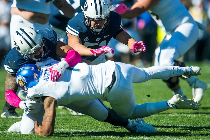 (Chris Detrick  |  The Salt Lake Tribune)  Brigham Young Cougars defensive lineman Sione Takitaki (16) and Brigham Young Cougars linebacker Morgan Unga (51) sack San Jose State Spartans quarterback Montel Aaron (7) during the game at LaVell Edwards Stadium Saturday, October 28, 2017.  