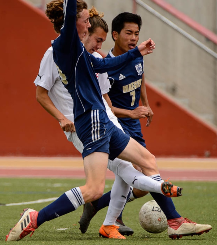(Trent Nelson | The Salt Lake Tribune)  Judge Memorial's Cameron Lundy (10 ) defended by Maeser Prep's Ethan Lynsky (9) and Maeser Prep's Winson Ha (7) in the Class 3A boys' soccer state quarterfinal between Judge Memorial and Maeser Prep in Salt Lake City, Saturday May 5, 2018.