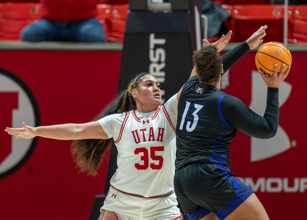 (Rick Egan | The Salt Lake Tribune)  Weber State Wildcats forward Amelia Raidaveta (13) looks to shoot, as Utah Utes forward Alissa Pili (35) defends at the Huntsman Center on Thursday.
