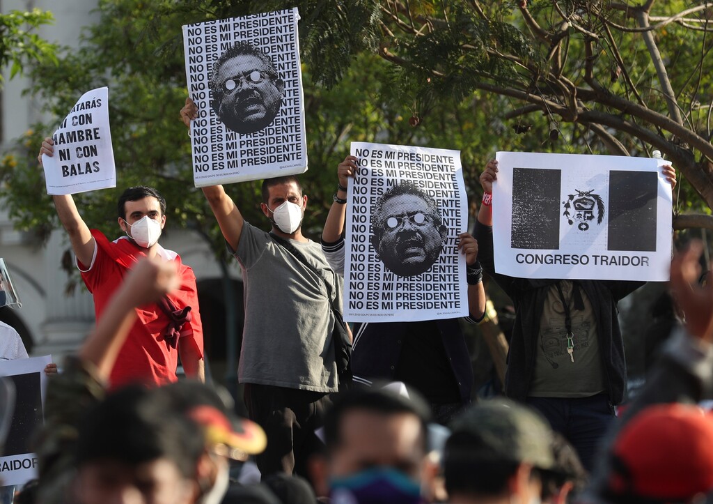 (Martin Mejia | The Associated Press) Protesters hold posters with images depicting Peru's newly sworn-in president Manuel Merino with a message that reads in Spanish: "Merino is not my president," in Plaza San Martin, in Lima, Saturday, Nov. 14, 2020. Peru's Congress voted overwhelmingly to remove now ex-President Martín Vizcarra on Monday.