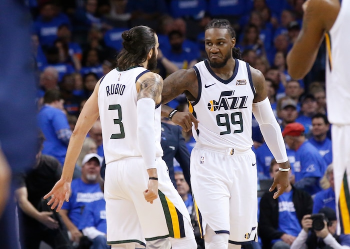 Utah Jazz forward Jae Crowder (99) celebrates with Ricky Rubio (3) during a timeout in the second half of Game 5 of the team's NBA basketball first-round playoff series against the Oklahoma City Thunder in Oklahoma City, Wednesday, April 25, 2018. (AP Photo/Sue Ogrocki)