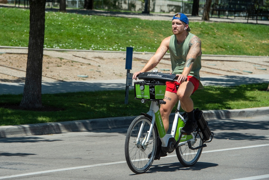 (Rick Egan  |  The Salt Lake Tribune)     William Deering rides a GREENbike down 300 East in Salt Lake City on Thursday, Aug. 6, 2020. The nonprofit announced a new program giving low-income residents a deep discount on annual passes as a way to help them cope with the high cost of transportation.