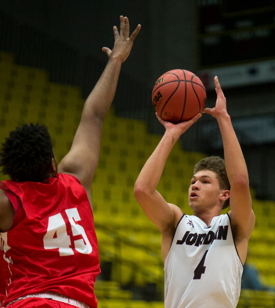 (Rick Egan  |  The Salt Lake Tribune)    Jordan Beatdiggers Dyson Koehler (4)shoots as East Leopards Mikey Frazier (45) defends, in 5A basketball playoff action between the East Leopards and the Jordan Beatdiggers at the UCCU Center in Orem, Monday, Feb. 26, 2018.