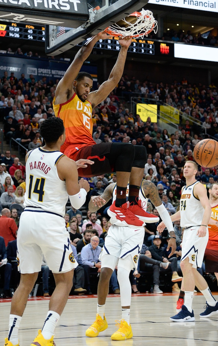 (Francisco Kjolseth  |  The Salt Lake Tribune)  Utah Jazz forward Derrick Favors (15) dunks as the Utah Jazz host the Denver Nuggets in their NBA game at Vivint Smart Home Arena Tuesday, April 9, 2019, in Salt Lake City.