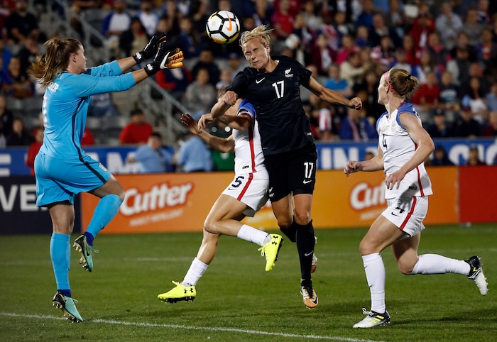 New Zealand forward Hannah Wilkinson (17) collides with U.S. defender Kelly O'Hara (5) while heading the ball past U.S. goalkeeper Alyssa Naeher (1) for a goal, as Becky Sauerbrunn (4) watches during the second half of an international friendly soccer match in Commerce City, Colo., Friday, Sept. 15, 2017. (AP Photo/Jack Dempsey)