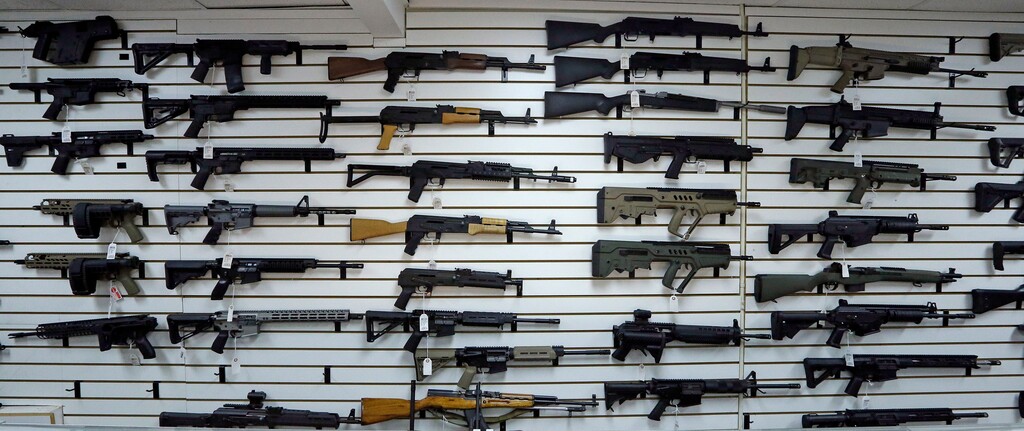 (Elaine Thompson | The Associated Press) Dozens of semi-automatic rifles line a wall in a gun shop Tuesday, Nov. 7, 2017, in Lynnwood, Wash. Gun-rights supporters have seized on the Texas church massacre as proof of the well-worn saying that the best answer to a bad guy with a gun is a good guy with a gun. Gun-control advocates, meanwhile, say the tragedy shows once more that it is too easy to get a weapon in the U.S.