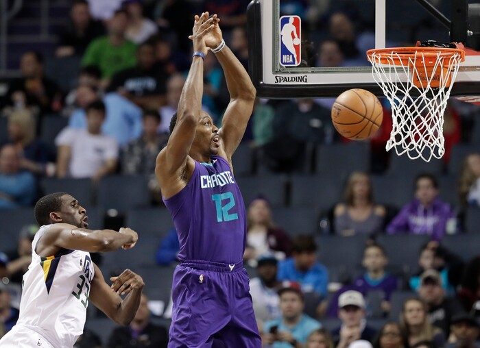 Charlotte Hornets' Dwight Howard (12) misses a lob pass as Utah Jazz's Ekpe Udoh (33) defends during the first half of an NBA basketball game in Charlotte, N.C., Friday, Jan. 12, 2018. (AP Photo/Chuck Burton)