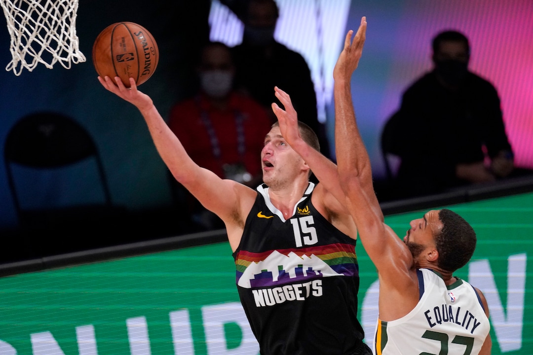 Denver Nuggets' Nikola Jokic (15) goes up for a shot as Utah Jazz's Rudy Gobert (27) defends during the second half an NBA first round playoff basketball game, Tuesday, Sept. 1,2020, in Lake Buena Vista, Fla. (AP Photo/Mark J. Terrill)