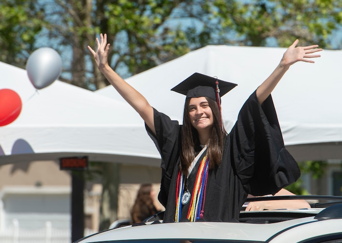 (Rick Egan  |  The Salt Lake Tribune)     Chandler Mondeaux waves as she rides in the parade of 2020 graduates in a “drive through” graduation ceremony at Alta High, Thursday, May 28, 2020.