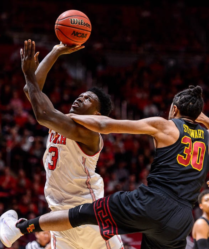 (Trent Nelson | The Salt Lake Tribune)  Utah Utes forward Donnie Tillman (3) is fouled by USC Trojans guard Elijah Stewart (30) as the University of Utah hosts USC, NCAA basketball at the Huntsman Center in Salt Lake City, Saturday Feb. 24, 2018.