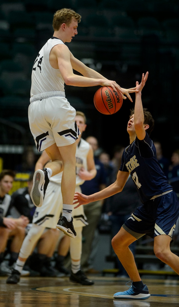 (Steve Griffin | The Salt Lake Tribune) Riverton's Richard Saunders leaps above Westlake's Kekoa Baker during the 6A basketball playoff game against Riverton at the Utah Valley UniversityÕs UCCU Center in Provo Tuesday Feb. 27, 2018.
