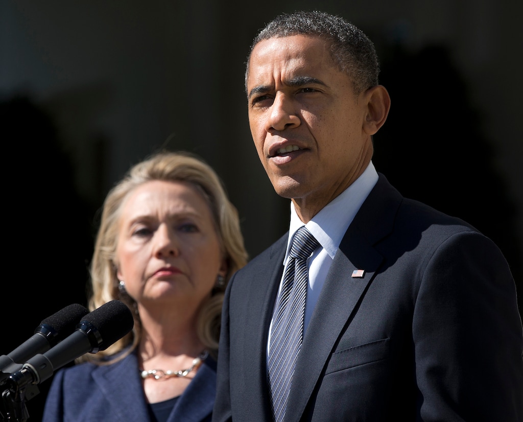 (Evan Vucci | The Associated Press) In this Sept. 12, 2012, file photo, then-Secretary of State Hillary Clinton listens at left, as President Barack Obama speaks in the Rose Garden of the White House in Washington, on the death of U.S. ambassador to Libya Christopher Stevens. They’ve been bitter rivals, allies and colleagues. When they take the stage at their first joint campaign appearance on July 5, 2016, Obama and Clinton will show off a new phase in their storied relationship: co-dependents.