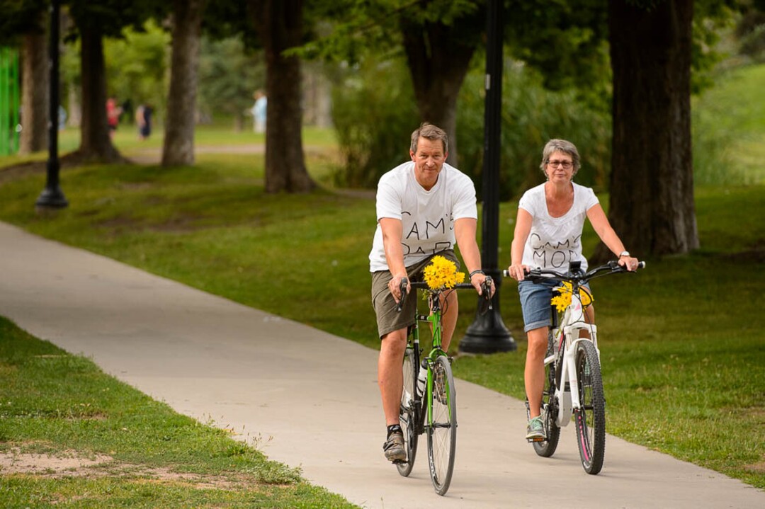 (Trent Nelson | The Salt Lake Tribune)Cyclists gather and ride around Salt Lake City's Liberty Park, Saturday July 21, 2018, in remembrance of Cameron Hooyer, a rider who was killed by a FrontRunner train during a 999 Ride on Thursday. Hooyer's parents Mark and Carla Hooyer.