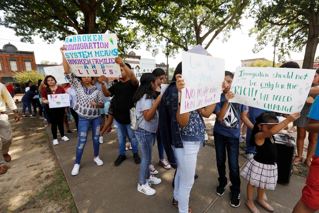 (Rogelio V. Solis | AP)  Children of mainly Latino immigrant parents hold signs in support of them and those individuals picked up during an immigration raid at a food processing plant, during a protest march to the Madison County Courthouse in Canton, Miss., following a Spanish Mass at Sacred Heart Catholic Church in Canton on Sunday, Aug. 11, 2019. The raids Wednesday at poultry plants in Mississippi have spurred churches that have been key to providing spiritual and emotional comfort to workers to now step up to provide material aid to jailed or out-of-work church members.