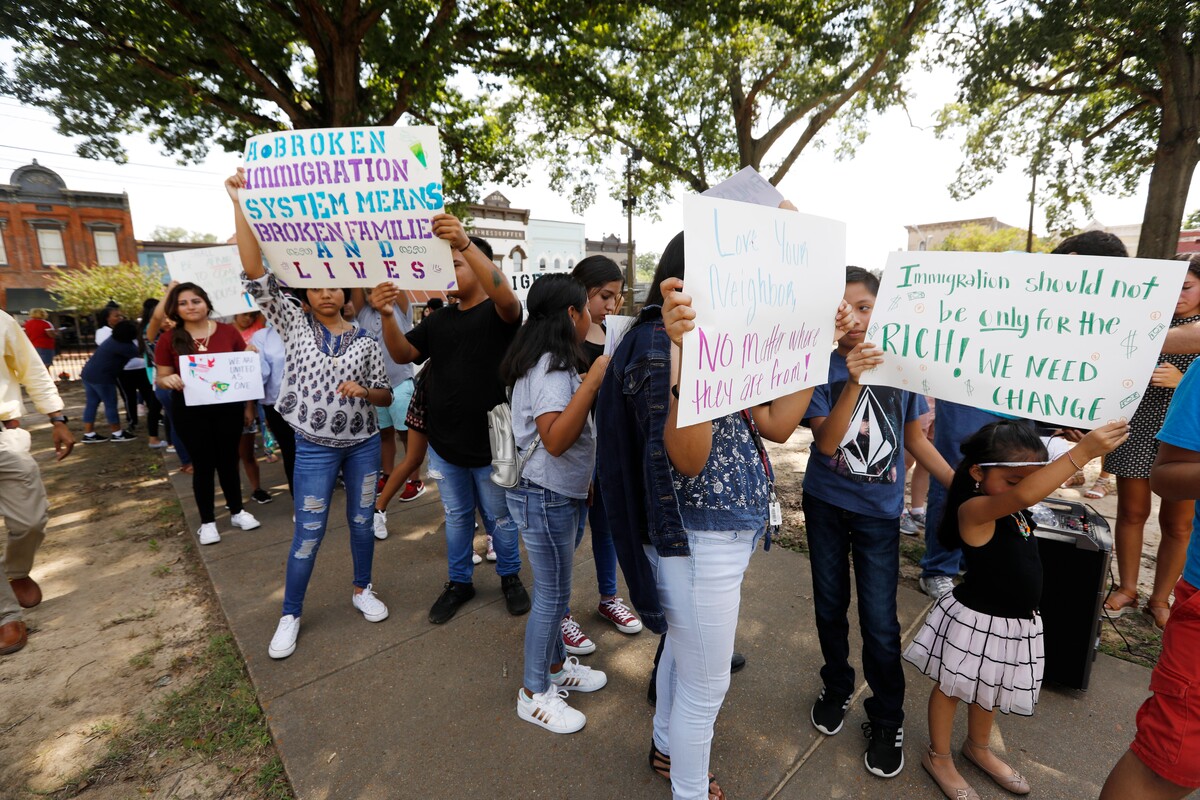 ‘Let our voices be heard’: Protesters march against immigration raids