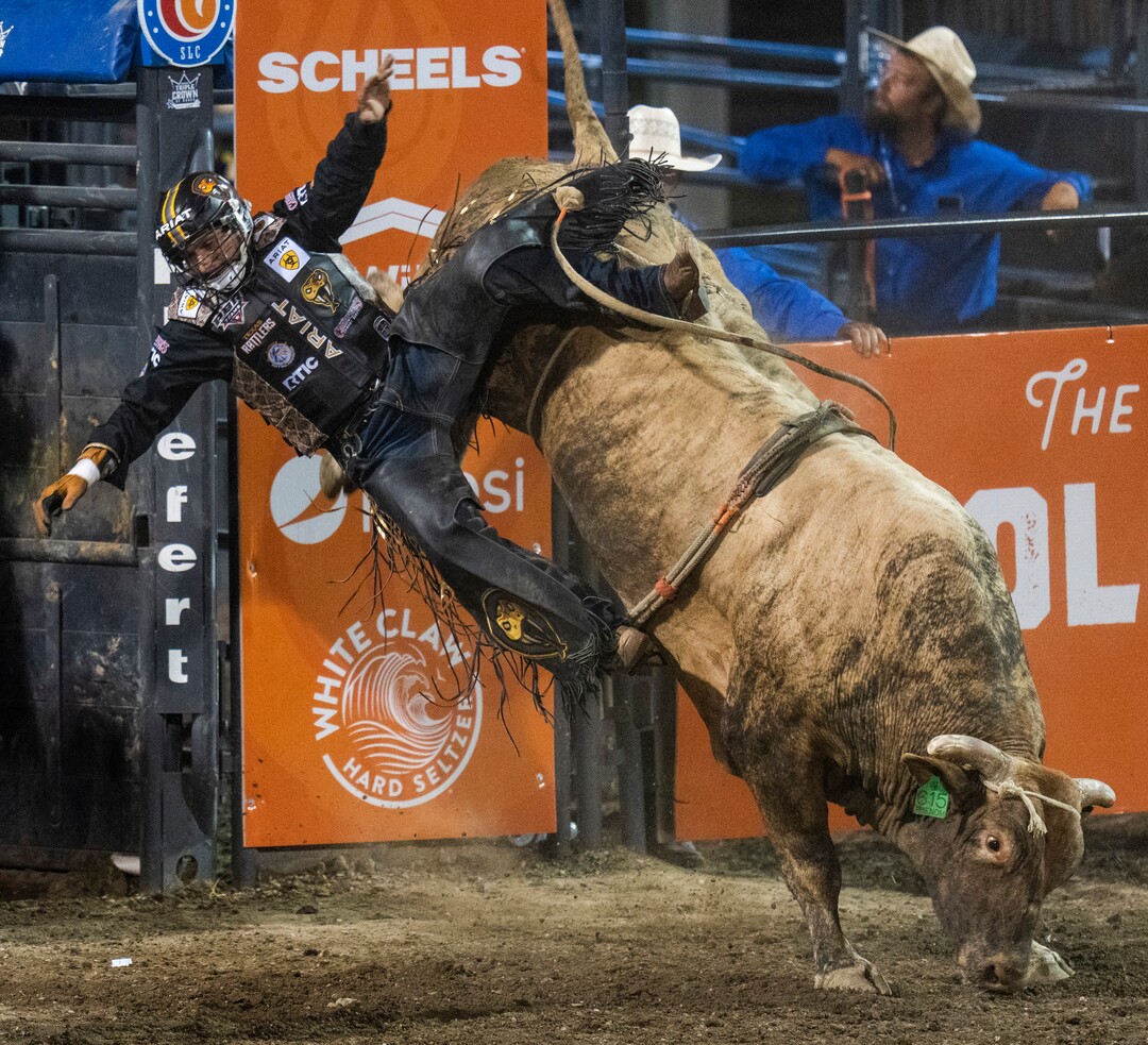 (Rick Egan | The Salt Lake Tribune)  Ednei Caminhas of Brazil competes in the bull riding event at the Utah Days of '47 Rodeo at the State Fairpark, on Monday, July 25, 2022.