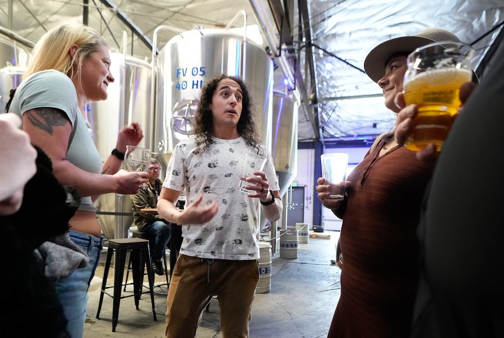 (Francisco Kjolseth | The Salt Lake Tribune) Brewer and podcaster David Jimenez, is joined by friends as they honor his contributions to the brewing community during a party at Kiitos Brewery in Salt Lake City on Friday, May 20, 2022. Jimenez is host and creator of The Taste Makers podcast.