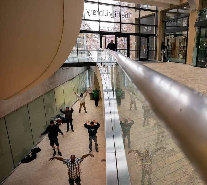 (Trent Nelson | The Salt Lake Tribune)  
A group of homeless people practice tai chi at the Main Library in Salt Lake City on Wednesday April 3, 2019.