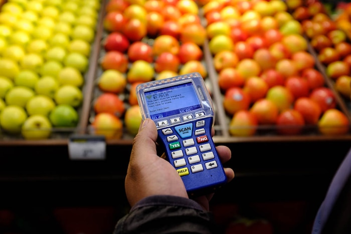 (Trent Nelson | The Salt Lake Tribune)  
Smith's has introduced handheld scanners to five Utah stores - where shoppers carry a small device and scan and bag their groceries as they walk through the aisles. Adrian Ortega demonstrated one of the units at the Rose Park store, Monday April 16, 2018.