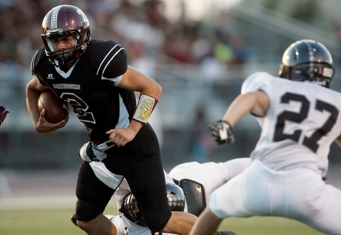 Chris Detrick  |  The Salt Lake TribuneJordan's Austin Kafentzis (2) runs past Alta's Brandon Smart (27) and Alta's Max Broman (9) during the first half of the game at Jordan High School Friday September 14, 2012.  Jordan is winning the game 20-17.