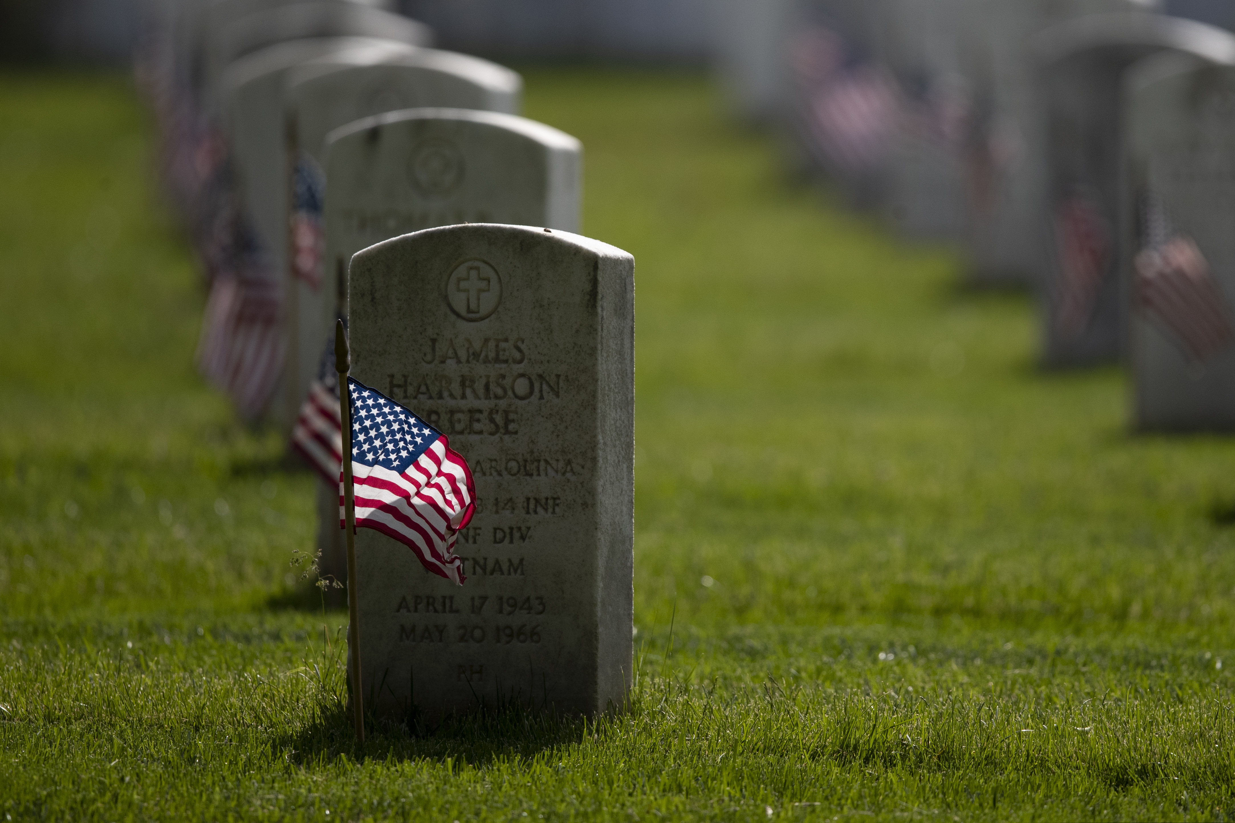 American flags are placed by members of the 3rd U.S. Infantry Regiment, also known as The Old Guard, in front of each headstone for "Flags-In" at Arlington National Cemetery in Arlington, Va., Thursday, May 21, 2020, to honor the Nation's fallen military heroes. (AP Photo/Carolyn Kaster)