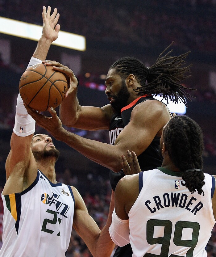 Houston Rockets center Nene Hilario, center, looks to pass as Utah Jazz center Rudy Gobert, left, and forward Jae Crowder (99) defend during the first half in Game 2 of an NBA basketball second-round playoff series Wednesday, May 2, 2018, in Houston. (AP Photo/Eric Christian Smith)